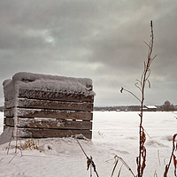Buy canvas prints of Snow Covered Wooden Crate On The Fields by Jukka Heinovirta