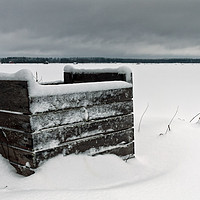 Buy canvas prints of Frozen Crates Covered With Snow by Jukka Heinovirta