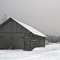 Buy canvas prints of Old Barn With Wide Doors By The Snowy Field by Jukka Heinovirta