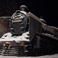 Buy canvas prints of Old Steam Engine Covered With Snow by Jukka Heinovirta