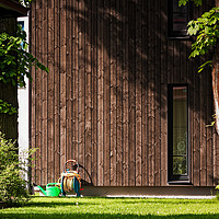 Buy canvas prints of Garden Tools Beside A Modern Building by Jukka Heinovirta