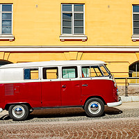 Buy canvas prints of Camper Van Parked By A Yellow Building by Jukka Heinovirta