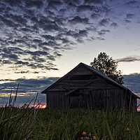 Buy canvas prints of Midsummer Sun Sets Behind An Old Barn House by Jukka Heinovirta