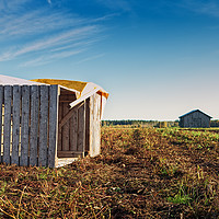 Buy canvas prints of Fallen Crates On An Autumn Field by Jukka Heinovirta