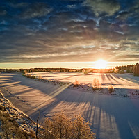 Buy canvas prints of Sun Rising Over The Frozen River by Jukka Heinovirta