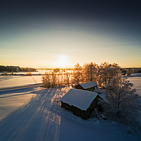 Buy canvas prints of Farm Houses In The Winter Sunset by Jukka Heinovirta