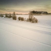 Buy canvas prints of Snow Mobile Tracks On An Icy River by Jukka Heinovirta