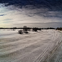 Buy canvas prints of Dramatic Sky Over The Icy River by Jukka Heinovirta