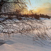 Buy canvas prints of Dramatic Sunset Over The Icy River by Jukka Heinovirta