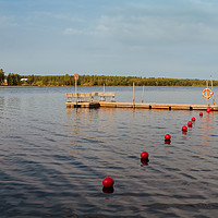 Buy canvas prints of Pier And Buoys On The Lake by Jukka Heinovirta