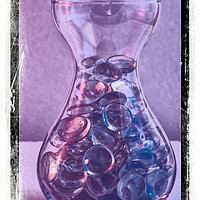 Buy canvas prints of Jar of glass pebbles in hues of blue and purple. by Paul Cullen