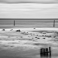 Buy canvas prints of Wooden posts in the sea. Monochrome. by Paul Cullen