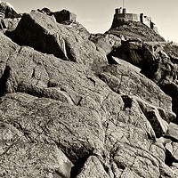 Buy canvas prints of Lindisfarne Castle over lichen covered rocks  - ye by Paul Cullen