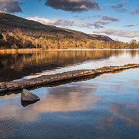 Buy canvas prints of The old stone jetty on the shore of a very still L by George Robertson