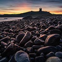 Buy canvas prints of First light on the rocks at Dunstanburgh Castle by George Robertson