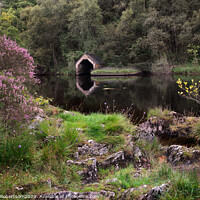 Buy canvas prints of Purple heather and reflections of an Old Boathouse by George Robertson