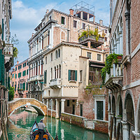 Buy canvas prints of Gondolier on Secluded Canal by Ian Collins
