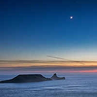 Buy canvas prints of The Moon over Worms Head, Rhossili Bay by Dan Santillo