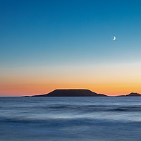 Buy canvas prints of Worms Head, Rhossili Bay with the moon by Dan Santillo
