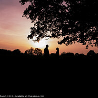 Buy canvas prints of Two people standing under a tree in front of a sunset by Sara Melhuish
