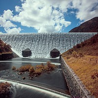 Buy canvas prints of Caban Coch dam in full flow by Russell Burton