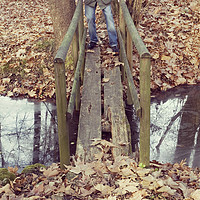Buy canvas prints of man standing on an old footbridge by saturno dona