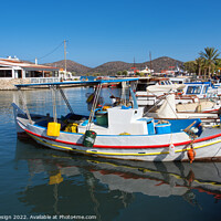 Buy canvas prints of Vibrant Fishing Boats in Elounda Harbour by Kasia Design