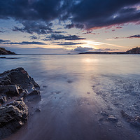 Buy canvas prints of Sunset at rocky beach with slow motion blur water by marcin jucha