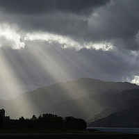 Buy canvas prints of Crepuscular rays over Eilean Donan Castle by Chris Drabble