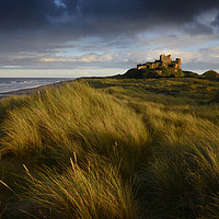 Buy canvas prints of Bamburgh Castle at sunset   by Chris Drabble