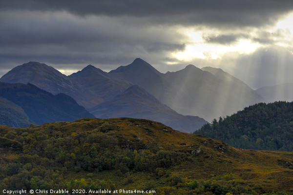 Crepuscular light rays over the Five Sisters Picture Board by Chris Drabble