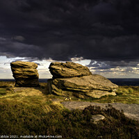 Buy canvas prints of The Ox Stones caught in storm light by Chris Drabble