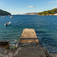 Buy canvas prints of Stone pier in the sea with mountains in the background by Sergey Fedoskin