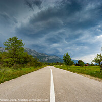Buy canvas prints of Empty countryside road in valley. Landscape with dramatic sky. A storm is coming from the mountains. by Sergey Fedoskin