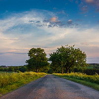 Buy canvas prints of Rural road in European countriside at sunset. by Sergey Fedoskin