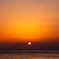 Buy canvas prints of Bright sunset with a big yellow sun under the sea surface. by Sergey Fedoskin