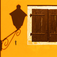 Buy canvas prints of Street lamp shadow on a yellow wall. by Tartalja 