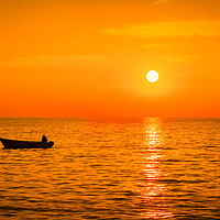 Buy canvas prints of Sea sunset with a fishermans boat silhouette. by Tartalja 