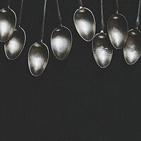 Buy canvas prints of A row of silver tea spoons laying on canvas cloth, background by Tartalja 