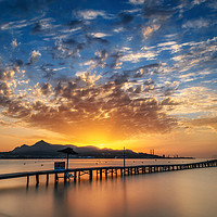 Buy canvas prints of Puerto de Alcudia beach pier at sunrise in Mallorc by Andrei Bortnikau