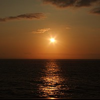 Buy canvas prints of Golden setting sun on sea by Harvey Watson