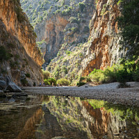 Buy canvas prints of Tranquil Waters Beneath Mallorcan Peaks by Bruce Little