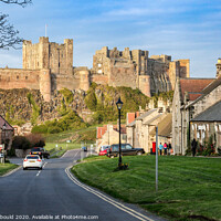 Buy canvas prints of Bamburgh Castle and village, Northumberland by Joy Newbould