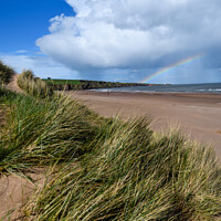 Buy canvas prints of A stunning rainbow over Luananbay beach by Joe Dailly