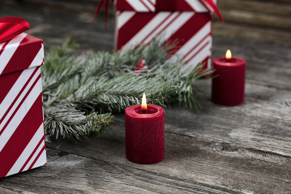 Burning red candle with decorations in background for a merry Ch Picture Board by Thomas Baker