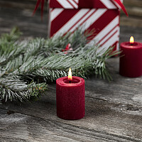 Buy canvas prints of Burning red candle with decorations in background for a merry Ch by Thomas Baker