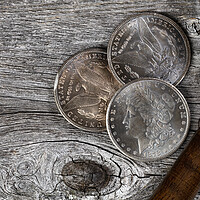 Buy canvas prints of Collection of US Morgan silver dollars with magnifying glass  by Thomas Baker