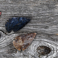 Buy canvas prints of Three Native American arrowheads on rustic wood  by Thomas Baker