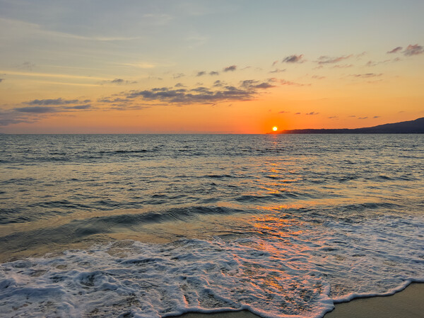 Lovely warm sunset over the Pacific Ocean in Mexico  Picture Board by Thomas Baker
