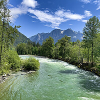 Buy canvas prints of Gem green color Skykomish river with snowcapped cascade mountain by Thomas Baker
